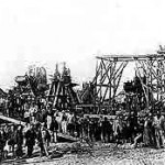 A construction site: engineers and workers posing beside their dredgers