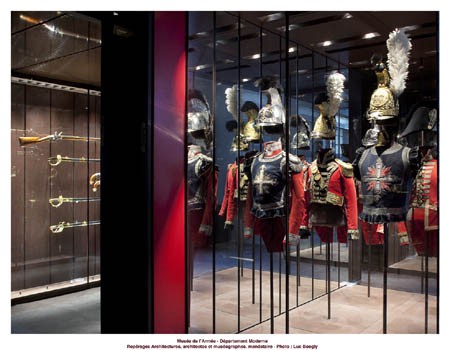 <i>Modern Gallery, Musée de l’Armée. Photo Luc Boegly</i>” /> <BR><STRONG>E.R.: </STRONG>As with every opening of a new room at the Musée de l'Armée, the Modern wing's new rooms are conceived as part of the museum as a whole but, at the same time, they also take into account the specificity of each collection on display. With regards to the rooms devoted to the period 1643-1871, the first section of which was reopened to the public for the last “Nuit des musées” event, we have tried to realise a number of different goals, which take into account the nature of the collections, their history, and the expectations of the public. <!-- /paragraph4 --></p>
<p><!-- paragraph5 --><!-- paragraphimage5 -->Our watchwords in this case could easily be: show, explain, inspire. For <EM>show</EM>, we have placed the emphasis on the items and their relationship with the space. Not only have we opened up the exhibition space, but we have also varied the angles, through various tricks with mirrors and a window scheme which allows, as far as it is possible, to observe each object in its three dimensions.  <BR><EM></EM> <BR><EM>Explain</EM> has been one of the key missions in the museum's transformation from object-centric to history-centric. The museum's public has diversified since the 1960s. As well as distinguished experts, school groups and families, we now get a huge number of foreigners, many of whom are completely unaware of much of France's history and its armies. On top of that, the male-female visitor split is now fifty-fifty. This is why it was essential that we put in place information tools that responded to everyone's particular needs. More than one-hundred and twenty information panels have been added to the rooms that cover the period 1643-1814, organized based on their content and the type of information they display: general history, the items in the room, details concerning one unit or one campaign… Other aids which will allow the visitor to investigate more closely certain aspects of the history on display (object-life, science and technology, strategy…) will also be integrated into the rooms. These will include interactive displays and animated battle plans. <BR> <BR>It is through marrying the aesthetic and the transmission of information that the museum hopes to <EM>inspire</EM> the public's interest for the history and collections on display.<!-- /paragraph5 --></p>
<p><!-- paragraph6 --></p>
<h2>I.D.: Due to the new changes, some objects will no longer be on display: how do you make a decision on what stays and what doesn’t? What happens to these objects that are "rejected"? Have you envisaged a system of rotation or thematic temporary exhibitions?</h2>
<p><!-- paragraphimage6 --><BR><STRONG>E.R.: </STRONG>The new displays coupled with new regulations concerning public safety and general accessibility in the museum forced us to reduce ever so slightly the number of objects on display. In order to carry out this process of selection, we kept the guidelines simple: if, instead of three similar objects, we could only put one on display, that one would have to be the most important, the most authentic and the most attractive example available. We thus carried out a critical and exhaustive process of selection, in order to eliminate any copies, late additions or objects that were simply too fragile or had been damaged – often beyond repair – due to work carried out in the past. The items that, following this selection process, have not been kept on display will be stored in the museum's reserves. In the future, they may be incorporated back into the displays – although some will require “de-restoration” before being shown again – but in most cases, they will be included in temporary exhibitions on more specific topics.  <BR> <BR>As well as this, some of our objects are particularly sensitive to the light, which can cause serious and often irreversible damage. This means that we have to operate a policy of rotation, in the case of paper-based objects, or indeed of temporary display. However, if we had had to incorporate a similar policy of rotation for our textile collection, we would have had to cut those parts of the permanent exhibition by almost one third. Not only is our textile collection not as extensive as our other ones, but it also has fewer ‘duplicates'. In order to meet the public's expectations and put on permanent exhibit, for example, Napoleon I's grey overcoat worn on St. Helena, we took the decision to illuminate the display using a weaker ambient light-form. This we hope will satisfy the majority of our visitors and allow us to keep on display such a noteworthy and anticipated object.<!-- /paragraph6 --></p>
<p><!-- paragraph7 --></p>
<h2>I.D.: As curator of the modern wing at the Musée de l’Armée, which items have particularly interested you?</h2>
<p><!-- paragraphimage7 --> <BR><STRONG>E.R.:</STRONG> That's quite a delicate question: there is a great variety of objects in the museum's collections, all of which offer a wide range of emotions to those who are willing to give it a go. Some items, however, are of particular interest to me as historian: the splendid “Gardes de la Manche” partisan, decorated by Jean Bérain, or indeed the superb set of pistols made by N.-N Boutet for Napoleon I, all evoke the splendour of the State, the greatness of the men who governed it, and the importance that they accorded to military art. <BR> <BR>Other examples are testament to the technological progress made in France and the work of engineering innovators, such as Honoré Blanc and Jean-Baptiste Vaquette de Gribeauval, designers of the “1777 model” rifle. The museum possesses a n° 1 workshop copy of the rifle and a kit, still in its entirety, for verifying the components before assembly. <BR> <BR>And then there are pieces that evoke the sacrifice and suffering that anonymous soldiers endured, in the name of the Nation's ideals, at a time when the Nation was in the process of developing its own identity. Maréchal de Turenne's cuirass, General de La Roncière's uniform, ripped apart by eleven sabre slashes at the Battle of Wagram, General d'Aboville's prosthetic shoulder, and the simple pistol found on the battlefield at Waterloo are all such examples.<BR> <BR>Finally, there are some pieces that touch me as an art historian, such as the two magisterial portraits by Gros: one shows General Lasalle at the capture of Stettin, the skilful mix of heroism and modesty so becoming of the bold victor clearly evident; the other, more poignant, more intimate, but no less heroic, is of the parting moment between General de Lariboisière and his son at dawn before the Battle of Borodino.<!-- /paragraph7 --></p>
<p><!-- paragraph8 --></p>
<h2>I.D.: What would you hope that visitors to the museum, both French and foreign, retain from their visit?</h2>
<p><!-- paragraphimage8 --> <BR><STRONG>E.R.:</STRONG> We hope that our visitors, depending on their interests and their goals, will leave the museum having understood a little bit about modern-day France's (military) foundations, having satisfied their historical curiosity, but also having been moved by the heroism of yesteryear and, who knows, even perhaps having been surprised by what they have found. <BR> <BR>One final thing that I would like to add is that these wings are and will continue to be constantly updated. Every day we are working on improving the displays and the way we welcome our visitors. Museography, just like History, is a discipline that must be continually renewed to avoid becoming stale.<!-- /paragraph8 --></p>
<p><!-- paragraph9 --><!-- paragraphimage9 --><!-- paragraph10 --><!-- paragraphimage10 --></p>
									</div><!-- .entry-content -->
																		<div id=